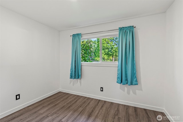 unfurnished room with wood finished floors and baseboards