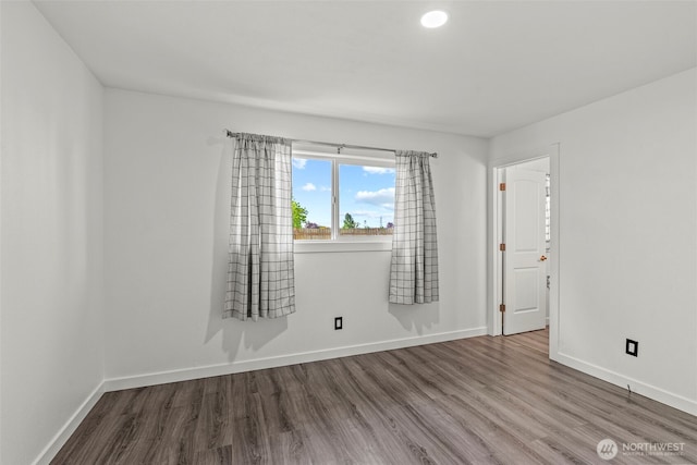 unfurnished room featuring wood finished floors and baseboards