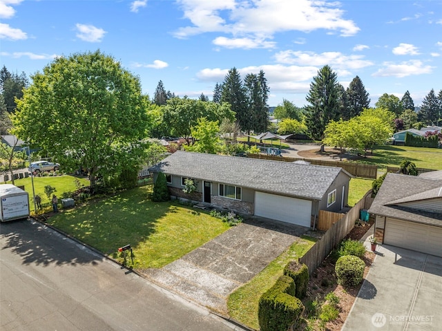 single story home with driveway and an attached garage