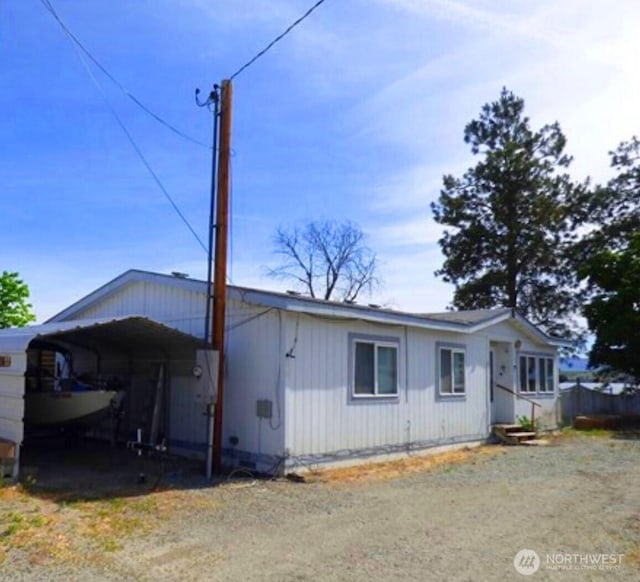 1061/2 Indian Ave E, Brewster, WA 98812 - view of front of house with driveway and a detached carport