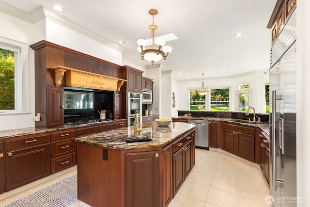 19516 67th Ave SE, Snohomish, WA 98296 - kitchen with built in appliances, a sink, crown molding, healthy amount of natural light, and hanging light fixtures