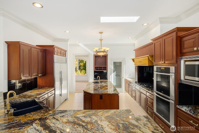 19516 67th Ave SE, Snohomish, WA 98296 - kitchen with a sink, appliances with stainless steel finishes, a chandelier, decorative backsplash, and dark stone counters