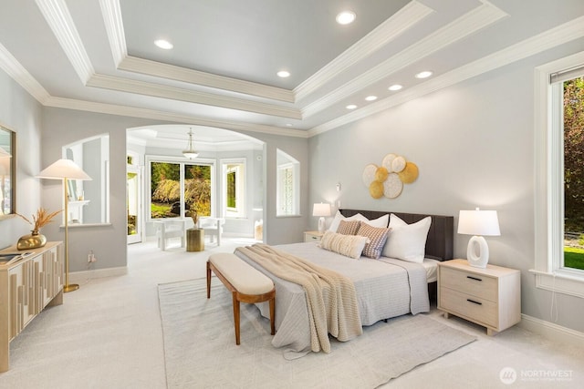 19516 67th Ave SE, Snohomish, WA 98296 - bedroom with arched walkways, a tray ceiling, light colored carpet, baseboards, and ornamental molding