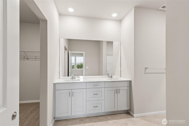 28307 74th Dr NW Unit 90, Stanwood, WA 98292 - full bathroom with double vanity, a walk in closet, and recessed lighting