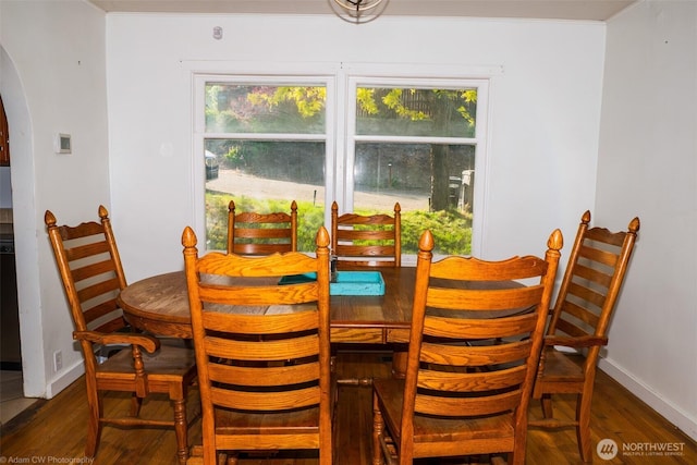 1803 Juniper St, Oroville, WA 98844 - dining space with arched walkways, wood finished floors, healthy amount of natural light, and baseboards