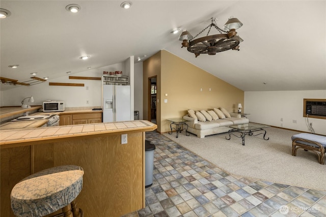 2262 Lambert Rd, Cle Elum, WA 98922 - kitchen with tile counters, white appliances, open floor plan, lofted ceiling, and a peninsula