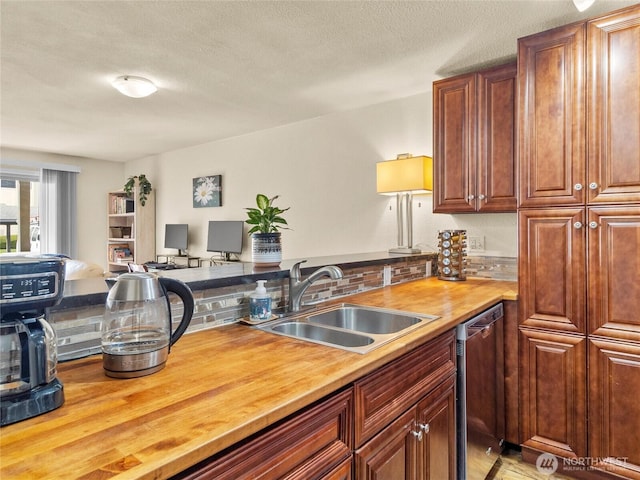 31003 14th Ave S Unit H1, Federal Way, WA 98003 - kitchen featuring wood counters, dishwasher, a sink, a textured ceiling, and a peninsula