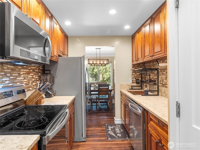 1420 153rd Ave NE # 4004, Bellevue, WA 98007 - kitchen featuring stainless steel appliances, brown cabinetry, dark wood-style flooring, recessed lighting, and backsplash