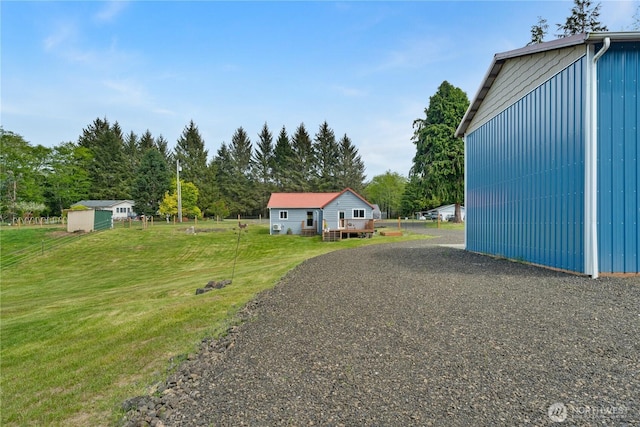 85 Rustemeyer Rd, Aberdeen, WA 98520 - view of grassy yard featuring an outdoor structure, a wooden deck, and view of scattered trees