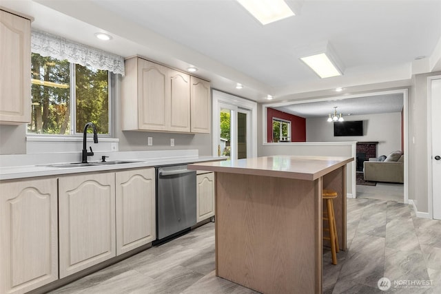 3123 163rd St E, Tacoma, WA 98446 - kitchen with stainless steel dishwasher, a sink, a center island, light countertops, and recessed lighting