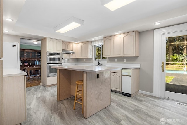 3123 163rd St E, Tacoma, WA 98446 - kitchen with a sink, stainless steel double oven, light countertops, a center island, and recessed lighting