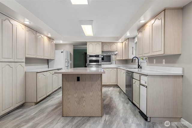 3123 163rd St E, Tacoma, WA 98446 - kitchen with a sink, stainless steel dishwasher, a kitchen island, light countertops, and recessed lighting