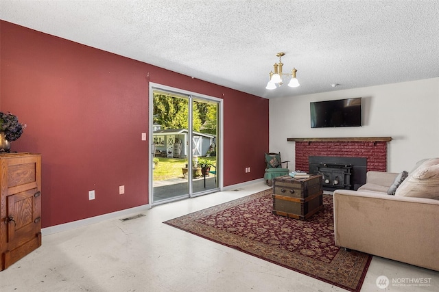 3123 163rd St E, Tacoma, WA 98446 - living room featuring baseboards, a textured ceiling, a chandelier, finished concrete flooring, and a fireplace