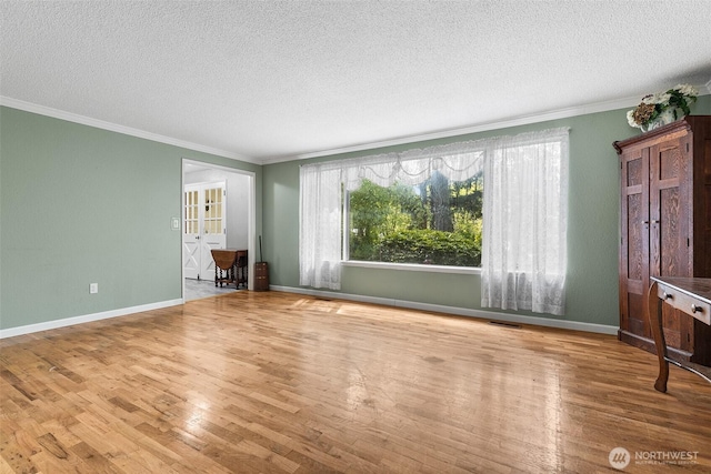 3123 163rd St E, Tacoma, WA 98446 - unfurnished living room with a textured ceiling, wood finished floors, ornamental molding, and baseboards