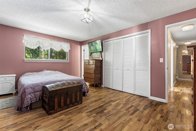 3123 163rd St E, Tacoma, WA 98446 - bedroom featuring wood finished floors, a textured ceiling, and a closet