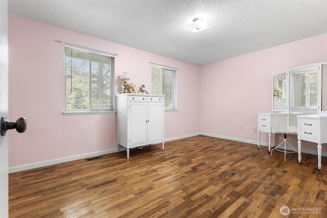 3123 163rd St E, Tacoma, WA 98446 - unfurnished bedroom with wood finished floors, a textured ceiling, and baseboards