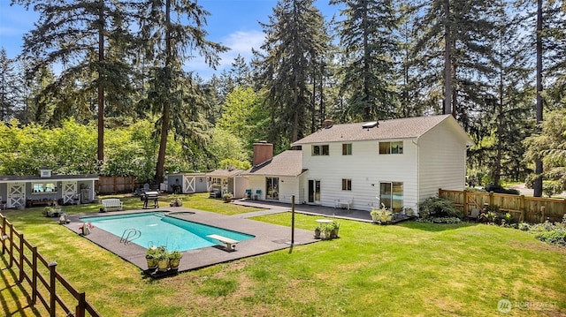 3123 163rd St E, Tacoma, WA 98446 - rear view of house with an outbuilding, a patio area, a chimney, and a storage shed