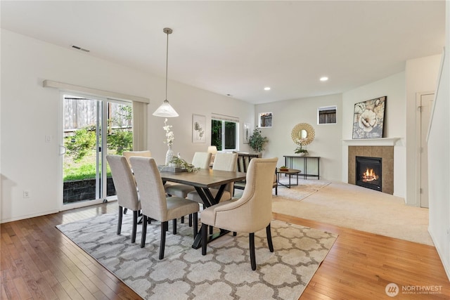 4135 240th Pl SE, Bothell, WA 98021 - dining space featuring hardwood / wood-style flooring, a tiled fireplace, recessed lighting, and baseboards