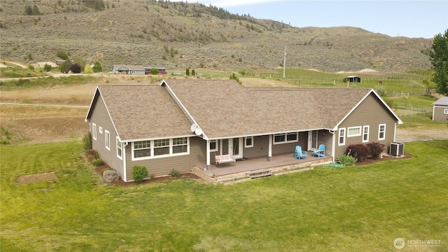 22 Rooster Flats Rd, Oroville, WA 98844 - back of property featuring central air condition unit, a lawn, roof with shingles, and a mountain view