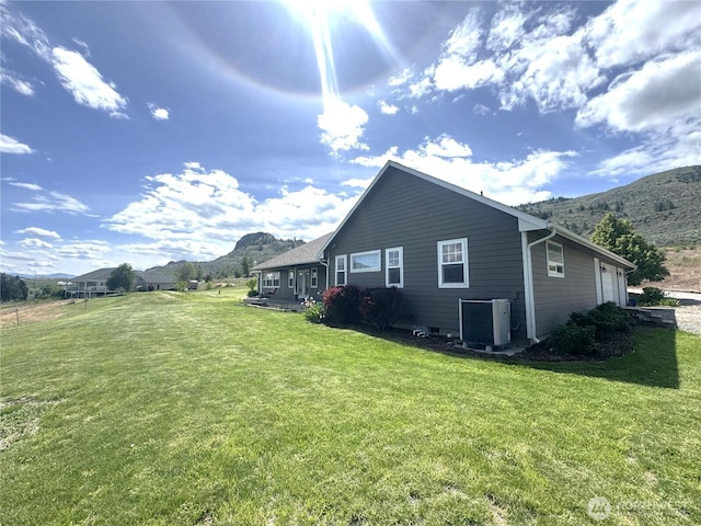 22 Rooster Flats Rd, Oroville, WA 98844 - view of side of property with a mountain view, central AC unit, and a lawn