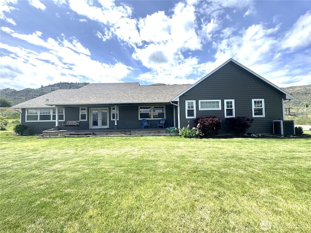 22 Rooster Flats Rd, Oroville, WA 98844 - back of property with french doors, a yard, and central air condition unit