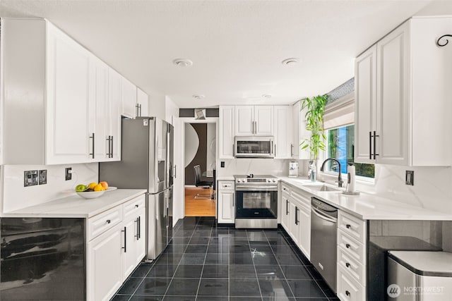 kitchen featuring appliances with stainless steel finishes, wine cooler, a sink, and white cabinetry