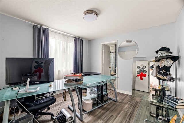dining room with an office area, wood finished floors, and baseboards