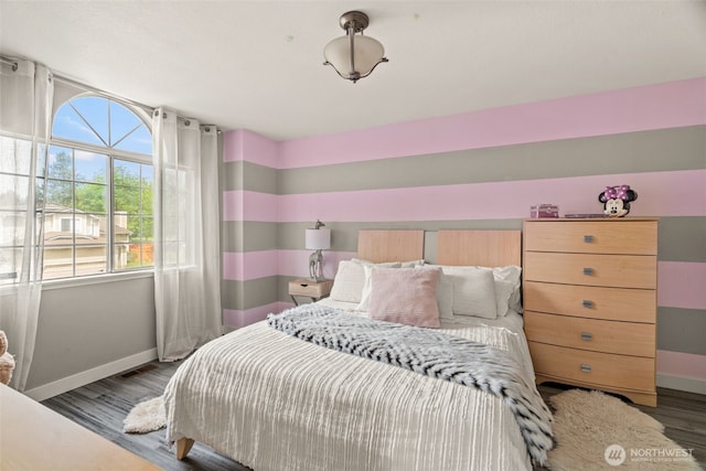 bedroom featuring baseboards and wood finished floors