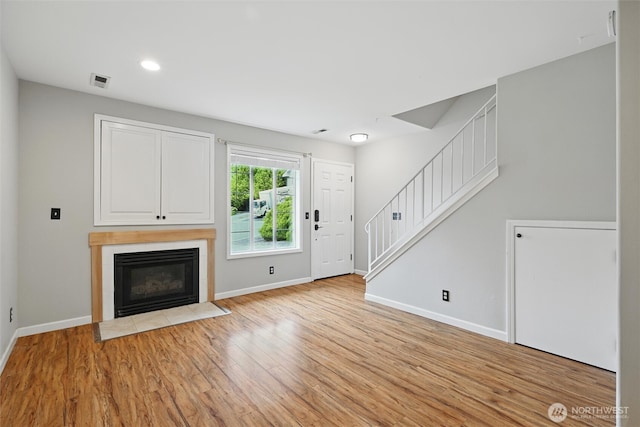 3454 Deer Pointe Ct, Bellingham, WA 98226 - unfurnished living room featuring baseboards, light wood-style floors, stairs, and recessed lighting