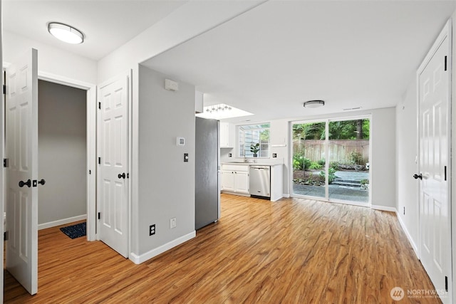 3454 Deer Pointe Ct, Bellingham, WA 98226 - unfurnished living room with light wood-type flooring, baseboards, and a sink