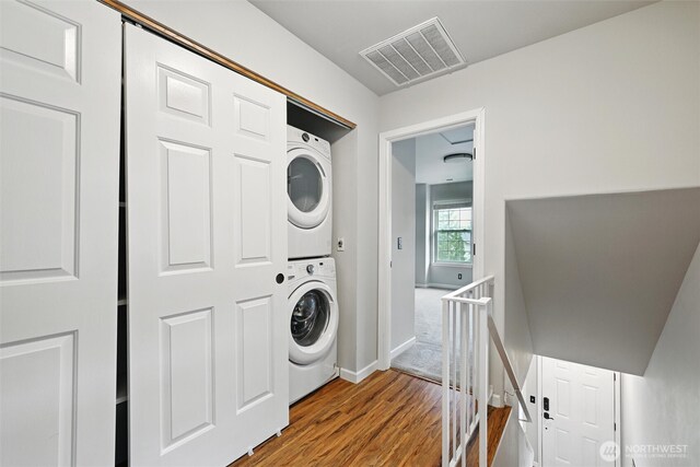3454 Deer Pointe Ct, Bellingham, WA 98226 - laundry room with estacked washer and dryer, wood finished floors, and baseboards