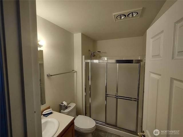 full bath with vanity, a shower stall, toilet, and tile patterned flooring