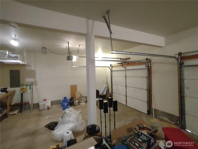 garage with a garage door opener and electric panel