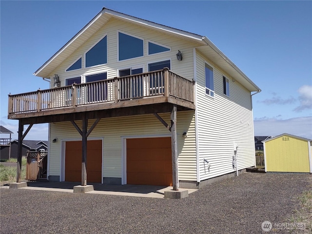 1400 Ocean Shores Blvd SW, Ocean Shores, WA 98569 - rear view of house featuring an attached garage, a deck, and a storage shed