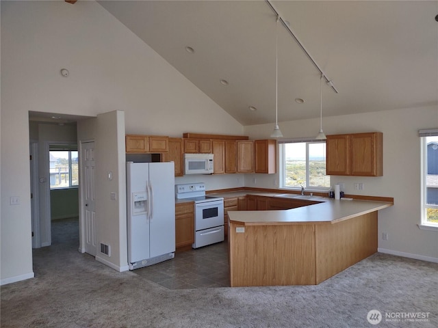 1400 Ocean Shores Blvd SW, Ocean Shores, WA 98569 - kitchen with white appliances, dark colored carpet, a peninsula, track lighting, and high vaulted ceiling