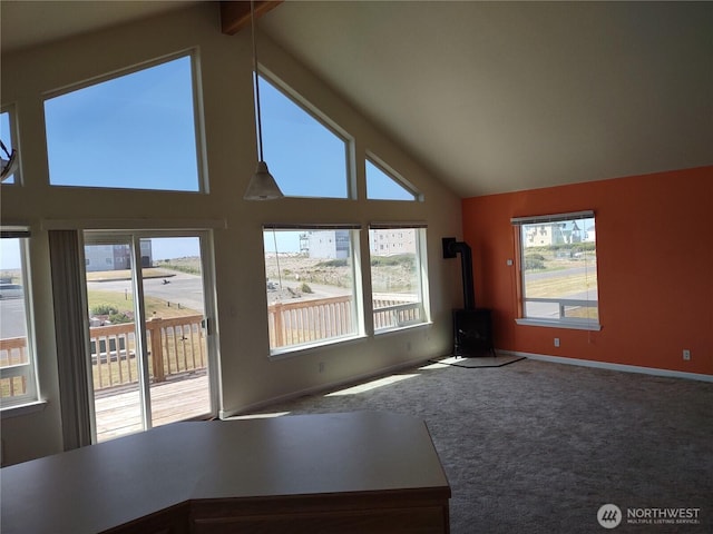 1400 Ocean Shores Blvd SW, Ocean Shores, WA 98569 - unfurnished living room with a wood stove, carpet flooring, and high vaulted ceiling