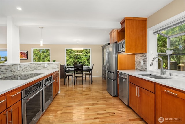10504 Dixon Dr S, Seattle, WA 98178 - kitchen with stainless steel appliances, a sink, light wood finished floors, light countertops, and recessed lighting
