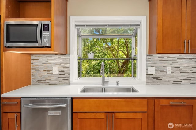 10504 Dixon Dr S, Seattle, WA 98178 - kitchen with appliances with stainless steel finishes, a sink, light countertops, and tasteful backsplash