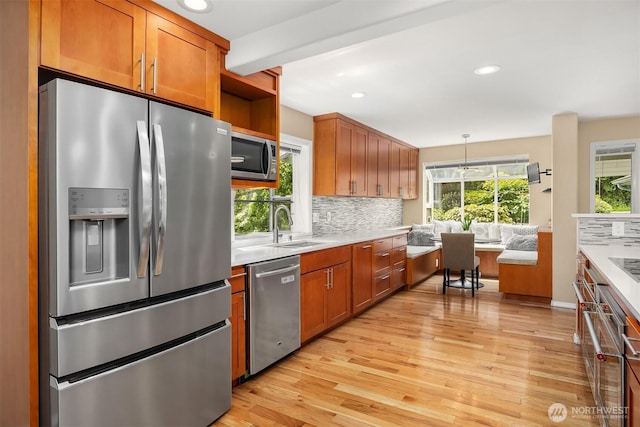 10504 Dixon Dr S, Seattle, WA 98178 - kitchen with stainless steel appliances, light countertops, light wood finished floors, tasteful backsplash, and recessed lighting