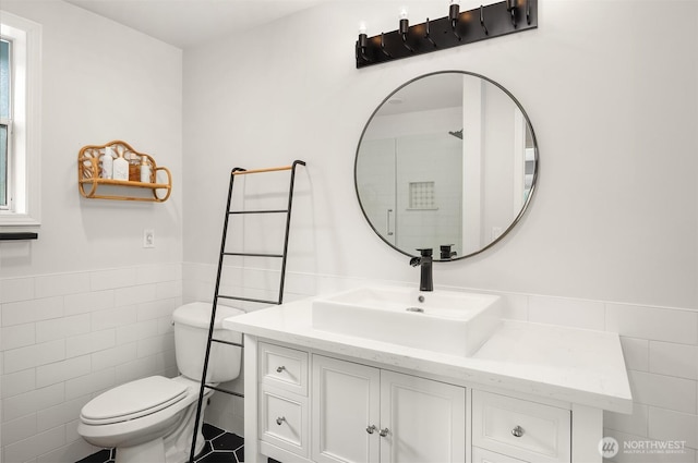 10504 Dixon Dr S, Seattle, WA 98178 - full bathroom featuring tile walls, toilet, vanity, and a wainscoted wall