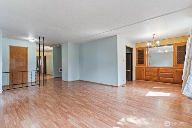 3213 85th St S Unit 48, Lakewood, WA 98499 - unfurnished living room with a chandelier and light wood-style floors
