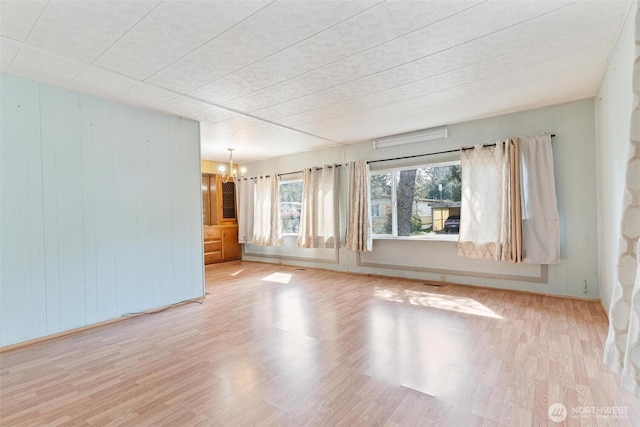 3213 85th St S Unit 48, Lakewood, WA 98499 - empty room with a chandelier, wood finished floors, and wood walls