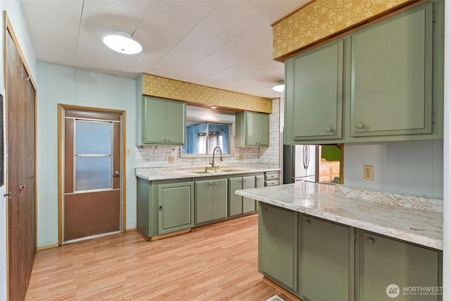 3213 85th St S Unit 48, Lakewood, WA 98499 - kitchen featuring green cabinets, a sink, light wood finished floors, freestanding refrigerator, and tasteful backsplash