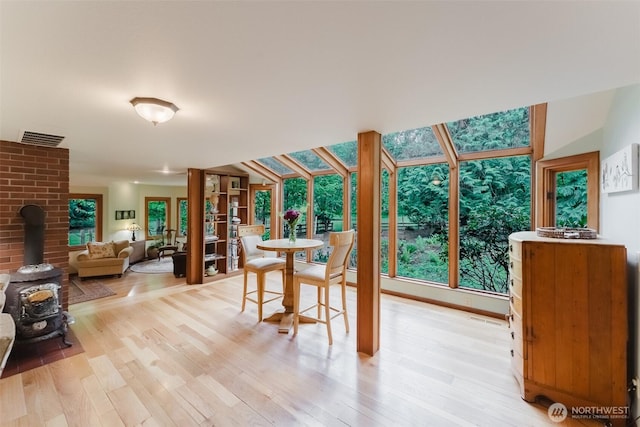 3246 Goshen Rd, Bellingham, WA 98226 - dining area with plenty of natural light, a wood stove, and light wood-style floors