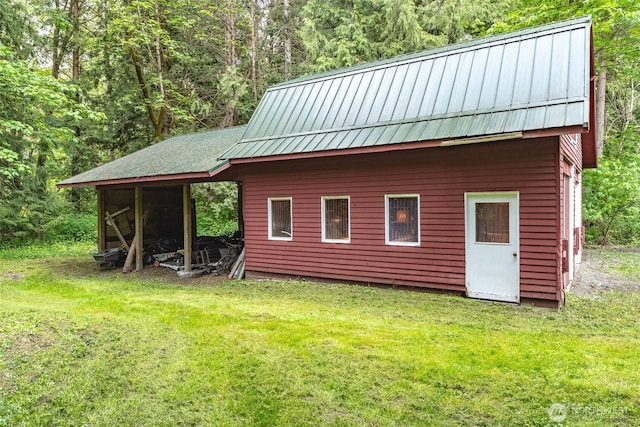 3246 Goshen Rd, Bellingham, WA 98226 - view of side of home with a yard, an outdoor structure, a metal roof, and a standing seam roof
