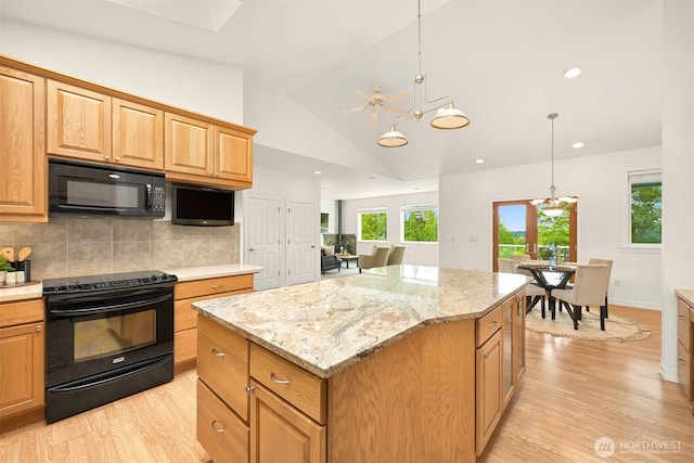 4415 Harborview Dr, Blaine, WA 98230 - kitchen featuring black appliances, light wood-type flooring, a chandelier, a kitchen island, and lofted ceiling