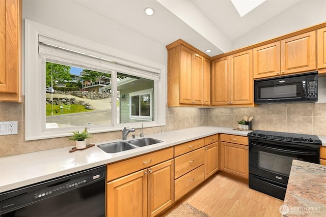 4415 Harborview Dr, Blaine, WA 98230 - kitchen featuring black appliances, a sink, light countertops, decorative backsplash, and light wood-style flooring