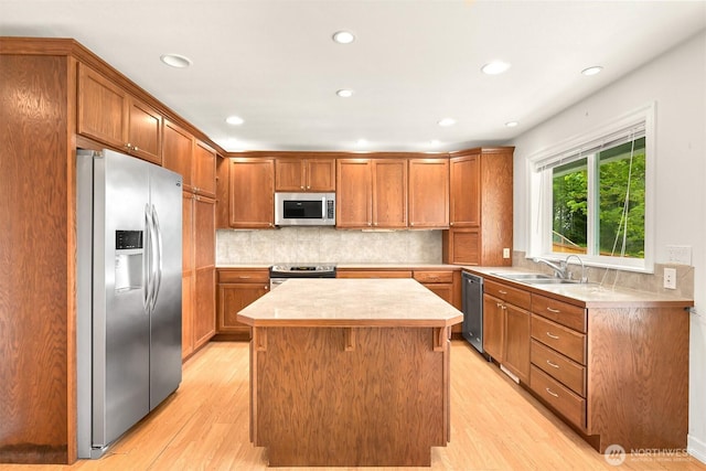 4415 Harborview Dr, Blaine, WA 98230 - kitchen featuring stainless steel appliances, a sink, light wood finished floors, light countertops, and a center island