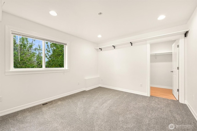 4415 Harborview Dr, Blaine, WA 98230 - unfurnished bedroom featuring carpet flooring, recessed lighting, baseboards, and a walk in closet
