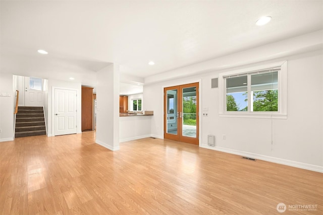 4415 Harborview Dr, Blaine, WA 98230 - unfurnished living room with light wood-style flooring, recessed lighting, baseboards, stairway, and french doors